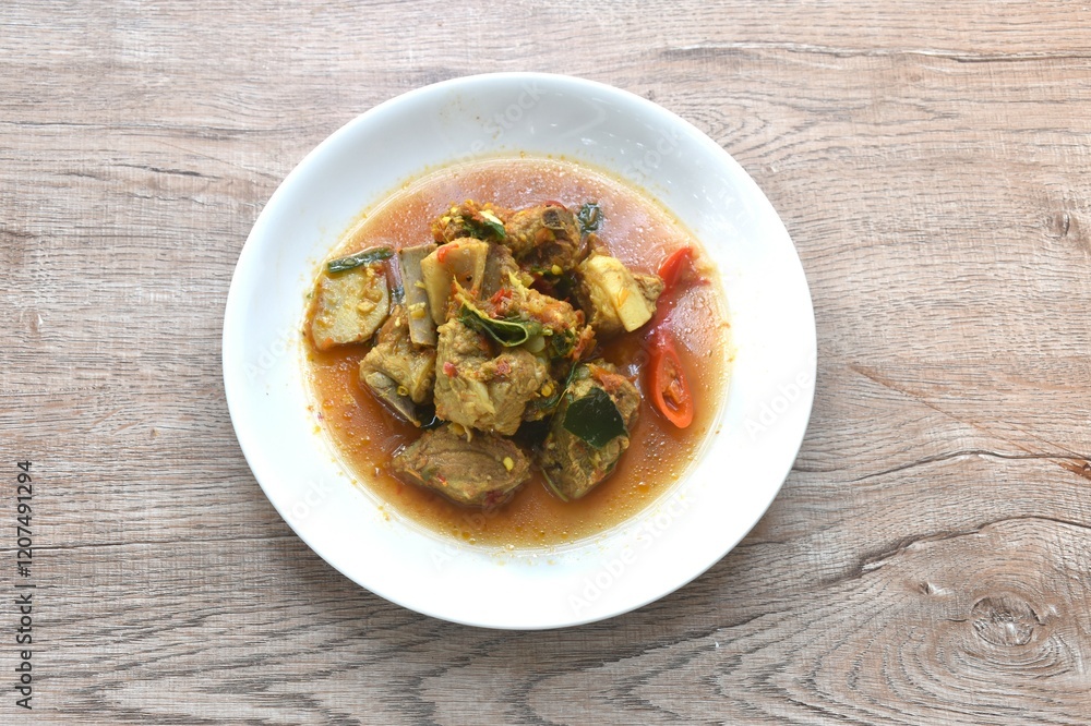 spicy fried pork soft bone with curry and basil on plate spicy fried pork soft bone with curry and basil on plate