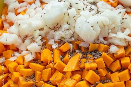 Pumpkin cubes and onion in spices. texture of diced pumpkin with onions and spices for filling pumpkin pie. High quality photo photo