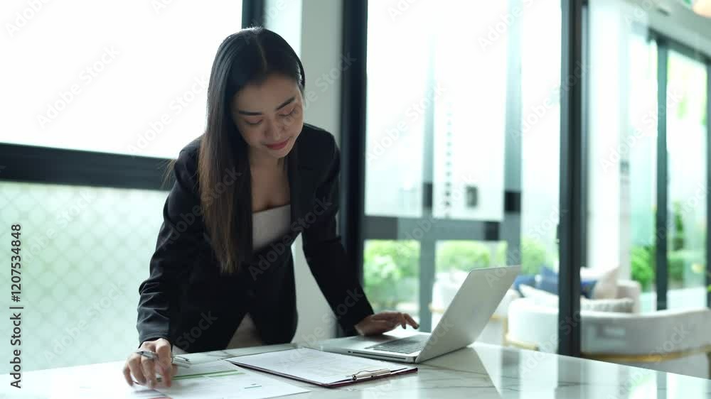 Asian businesswoman using laptop in office