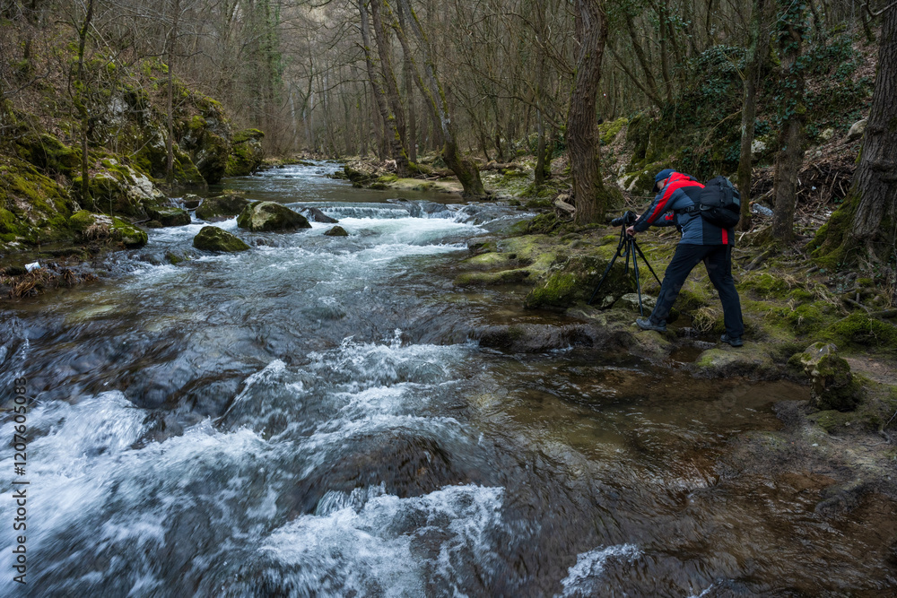 A nature photographer photographs a mountain river and its rapids. Photo of a mountain river and its surroundings.
A nature photographer photographs a mountain river and its rapids. Photo of a mountain river and its surroundings.