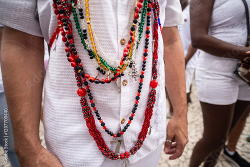 Candomble followers are seen wearing necklaces during the Bonfim washing procession in the city of Salvador, Bahia. photo