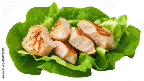 Grilled chicken pieces served on a bed of fresh green lettuce.