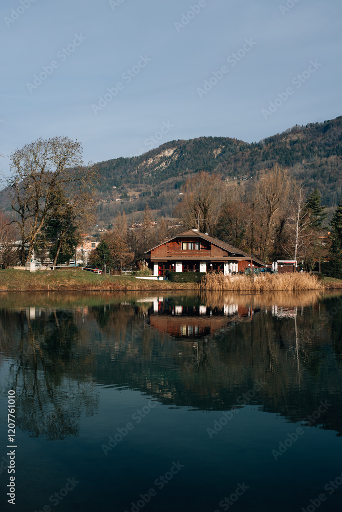 wooden house by the lake near the mountains in France wooden house by the lake near the mountains in France