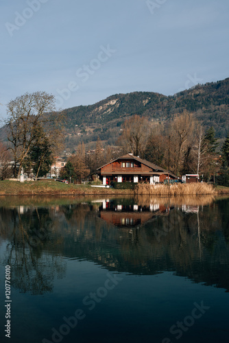 wooden house by the lake near the mountains in France photo