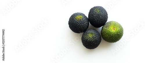 Four Black Lychee and Green Emerald Jenipapo Fruits Arranged on White Background with Copy Space for Text and Minimalistic Composition photo