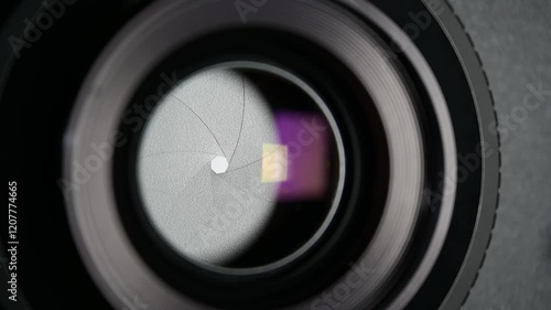 Photographic lens aperture with open and closed movements.