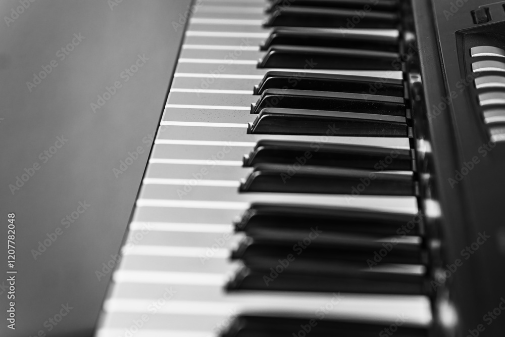 Close-up view of piano keys showcasing their elegant design and classic black and white contrast Close-up view of piano keys showcasing their elegant design and classic black and white contrast