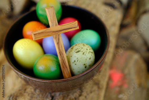 Colored Easter eggs with a wooden cross, for The Resurrection of Christ, most ancient Christian holiday, France photo