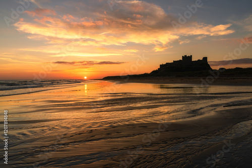 Bamburgh Castle at sunrise, Northumberland, England, United Kingdom photo