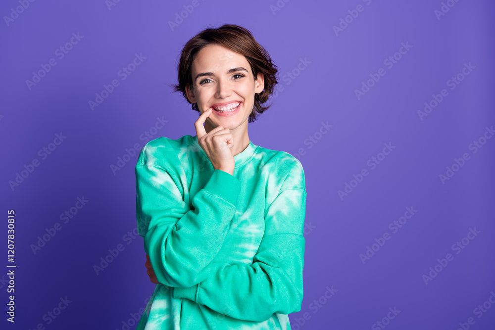 Photo portrait of attractive young woman touch chin cheerful dressed stylish green clothes isolated on violet color background Photo portrait of attractive young woman touch chin cheerful dressed stylish green clothes isolated on violet color background
