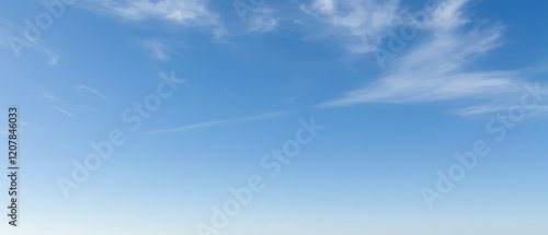 Vast blue sky with wispy cloud trails, dreamy feel