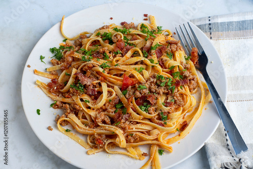 linquine  top with crumble  sausage, bacon  bits and parsley photo