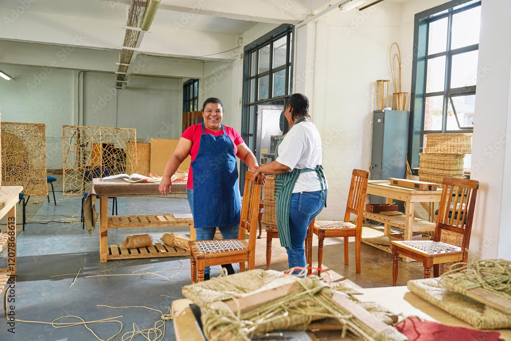Two female craftsmen making wicker furniture in workshop Two female craftsmen making wicker furniture in workshop