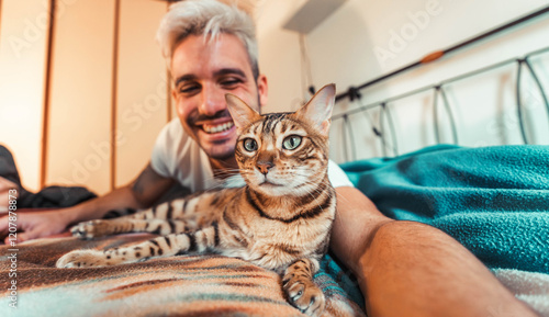 Photography Owner playing with cat relaxing on the bed at home - Happy man and bengal cat ta