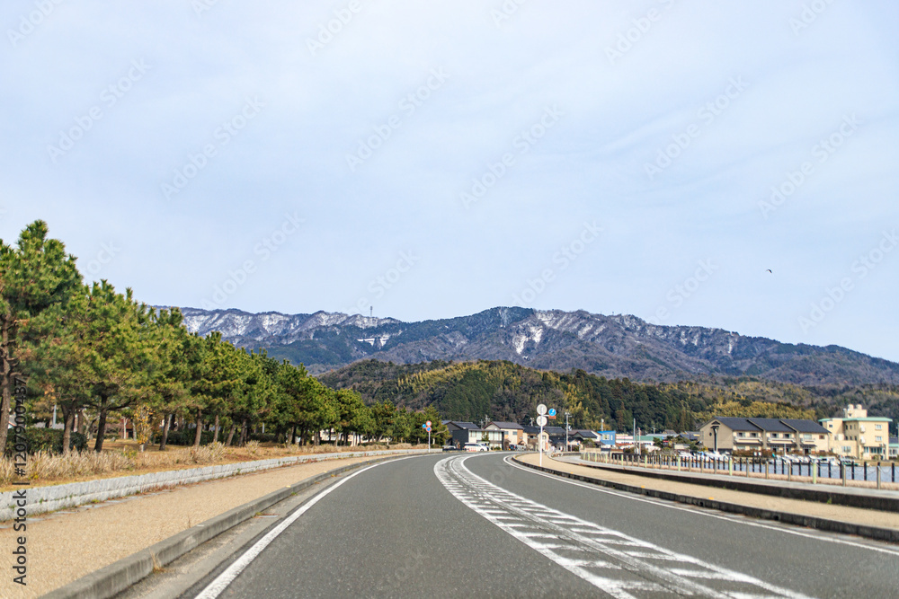 Road Leading Towards Snow-Capped Mountains in Rural Japan Road Leading Towards Snow-Capped Mountains in Rural Japan