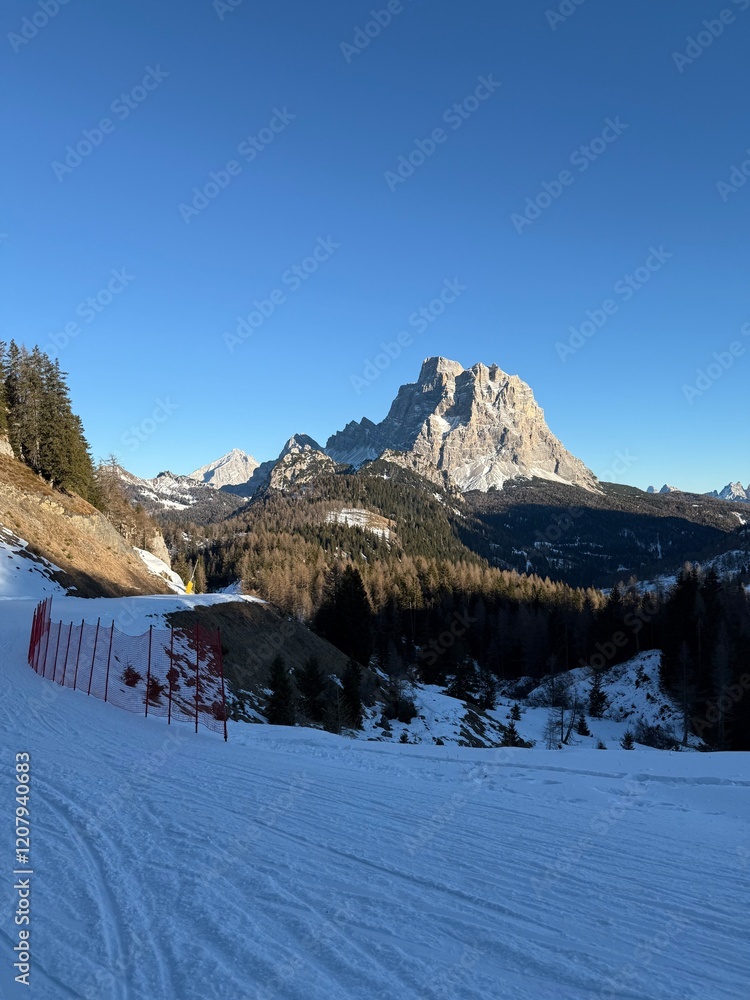 Fototapeta premium Panoramic view of the Dolomites mountains in winter, Italy. Santa Fosca Civetta resort.Ski resort in Dolomites, Alps in Italy. Aerial drone view of Santa Fosca ski slopes and mountains in dolomites.