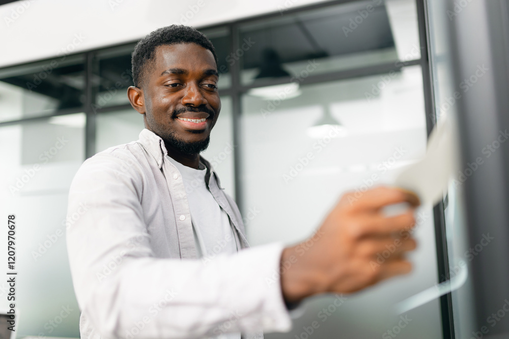 African American Professional Using task completion stickers in Office Setting African American Professional Using task completion stickers in Office Setting