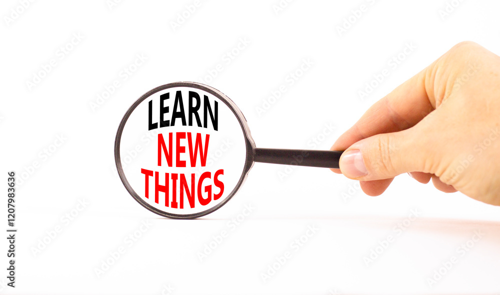 Learn new things symbol. Concept words Learn new things on beautiful black magnifying glass. Beautiful white background. Businessman hand. Business motivational learn new things concept. Copy space. Learn new things symbol. Concept words Learn new things on beautiful black magnifying glass. Beautiful white background. Businessman hand. Business motivational learn new things concept. Copy space.