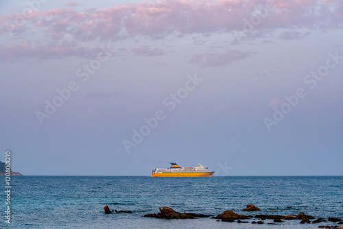 Ferry boat cruising on the mediterranean sea of Sardinia at sunset photo