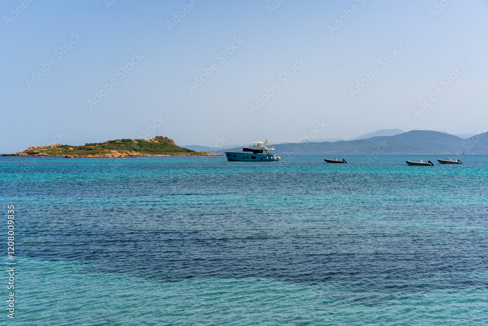 Sailing boats in the coast of Sardinia with turquoise water in Italy Sailing boats in the coast of Sardinia with turquoise water in Italy