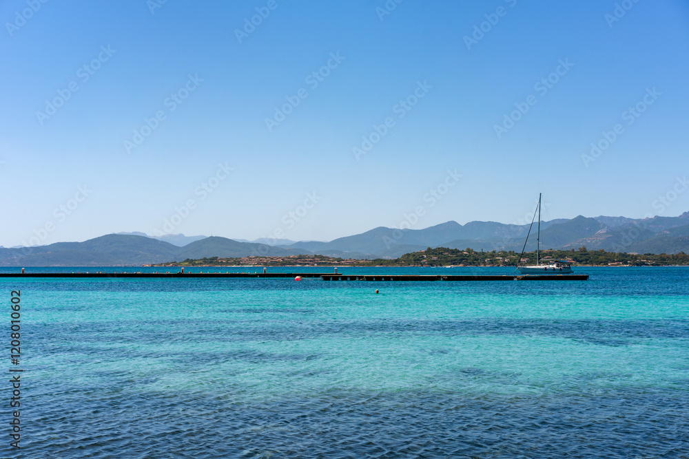 Sailing boats in the coast of Sardinia with turquoise water in Italy Sailing boats in the coast of Sardinia with turquoise water in Italy