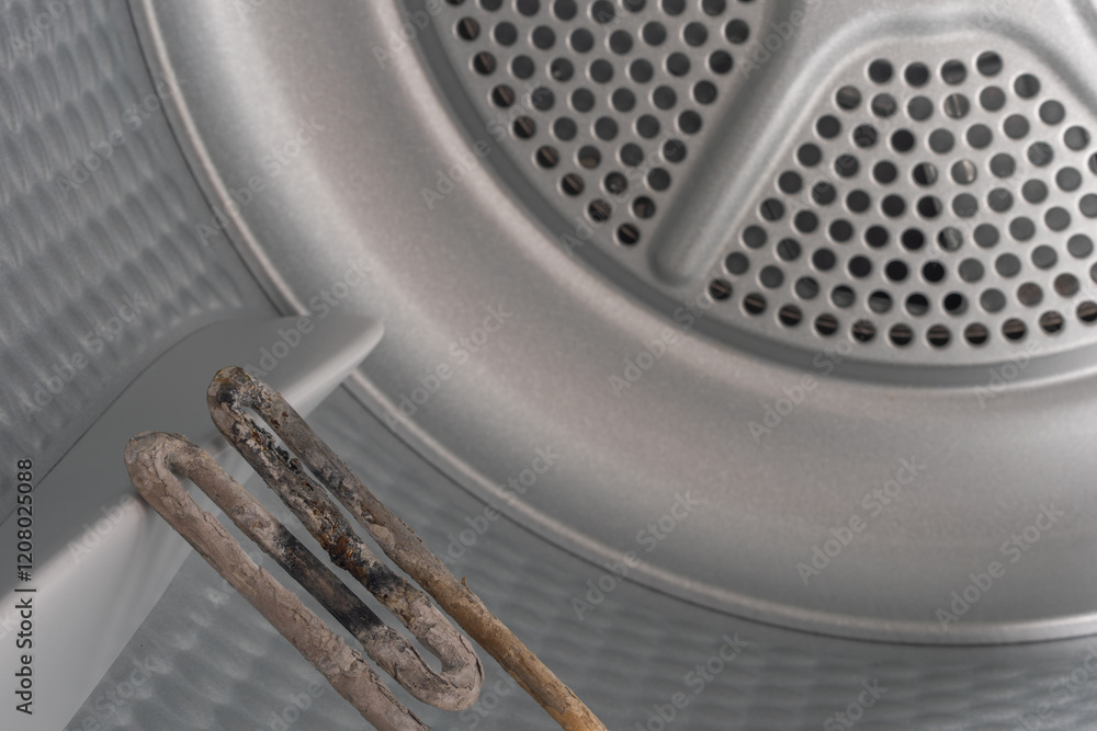 Inside the Washing Machine Drum: Corroded Heating Element Struggling with Mineral Deposits