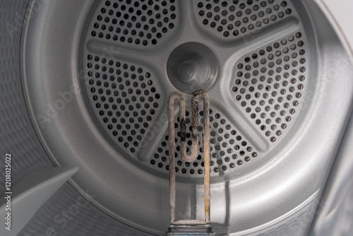 Obraz na płótnie Inside the Washing Machine Drum: Corroded Heating Element Struggling with Mineral Deposits w salonie