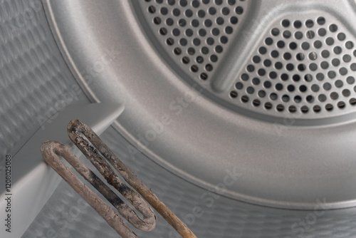 Obraz na płótnie Inside the Washing Machine Drum: Corroded Heating Element Struggling with Mineral Deposits w salonie