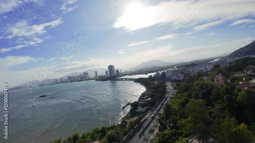 Aerial footage from FPV drone flying over Nha Trang city on a sunny day.  photo