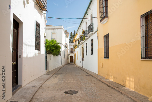 Empty street between houses in Cordoba, Spain.