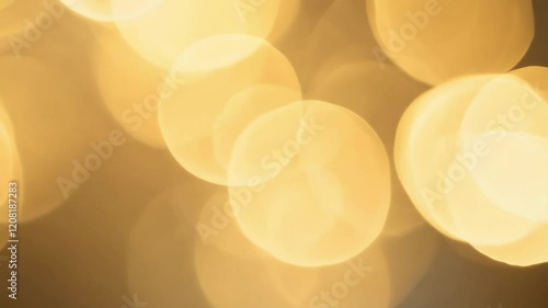Soft bokeh light effect with warm golden tones, creating a serene and abstract atmosphere. Perfect for artistic or festive background use with copy space.
