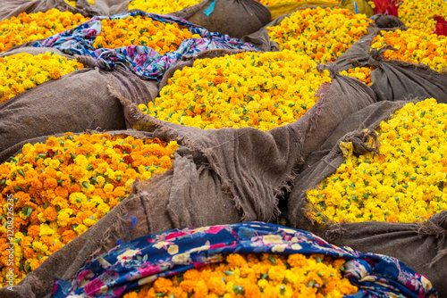Marigolds and roses flowerheads packed in sacks on Jaipur open market in Rajasthan, India