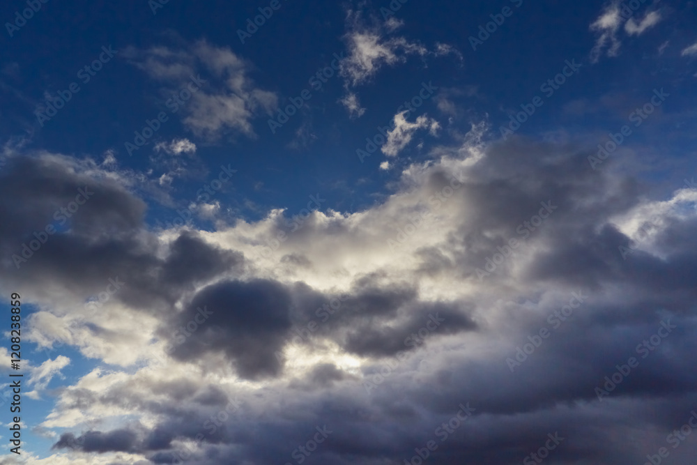 The sky with fluffy white-gray clouds bathed in the gentle light of the day. The sky with fluffy white-gray clouds bathed in the gentle light of the day.