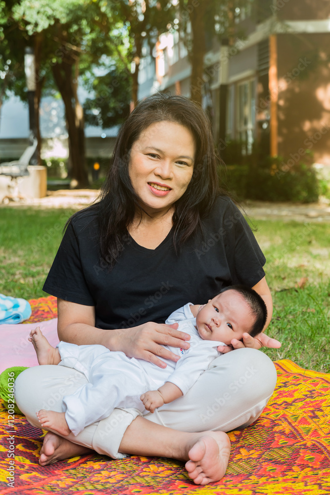 paternal grandmother and granddaughter on grass field paternal grandmother and granddaughter on grass field