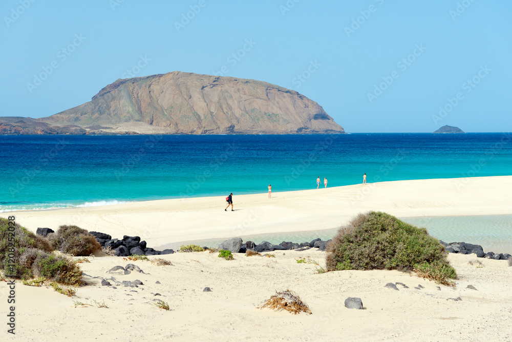 Lanzarote, Canary Islands. Over white sands of Playa de las Conchas on Isla Graciosa, Lanzarote. Toward island of Montana Clara
