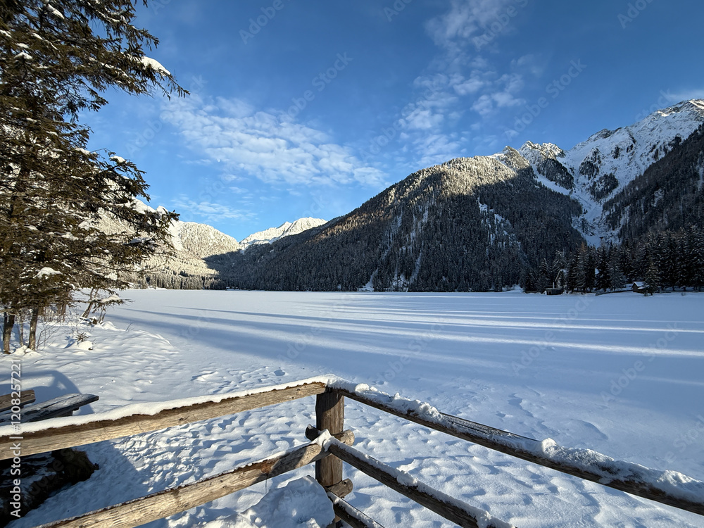 Fototapeta premium Lake Anterselva, Italy. Amazing view of the famous lake Anterselva in winter time. Frozen and snow-covered alpine lake. Alpine contest. Picturesque mountain lake at Dolomites. Wonderful nature contest
