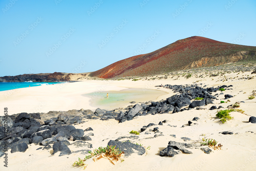 Lanzarote, Canary Islands. Along beach of Playa de las Conchas on Isla Graciosa, Lanzarote, to volcanic cone of Montana Bermeja