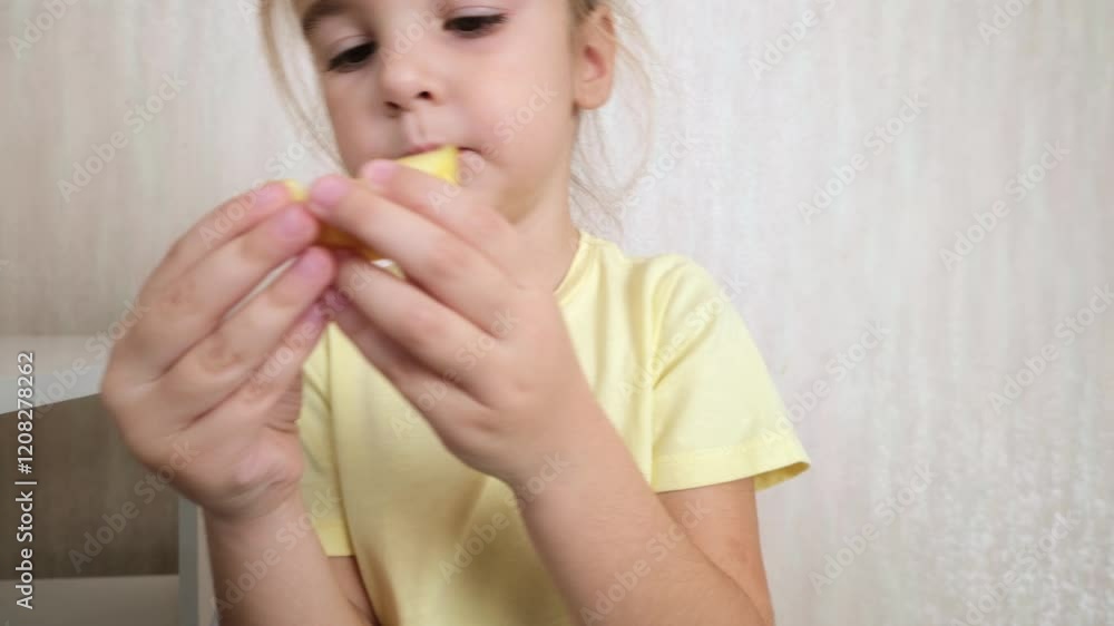 Little girl eating an apple in her room at home Little girl eating an apple in her room at home