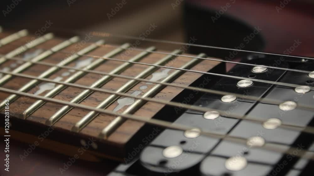 The human hand with pick plays chords the electric guitar. Vibration of metal strings The human hand with pick plays chords the electric guitar. Vibration of metal strings