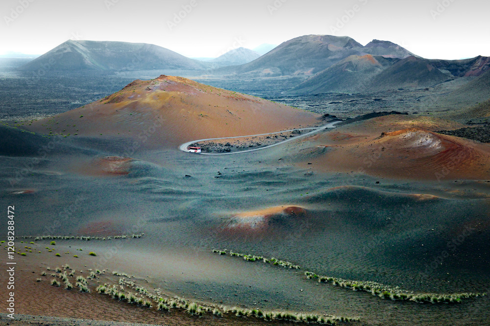 Over tour bus in the Volcanic cones and lava fields of Timanfaya National Park, Lanzarote, Canary Islands. West toward El Golfo