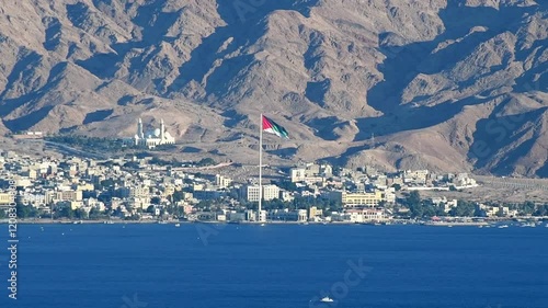 One of the biggest Jordanian mosque  - Al-Sharif Al-Hussein Bin Ali and highest in the Middle East National flag of Arabian Revolt, attractions are located above marine port of Aqaba city, Jordan