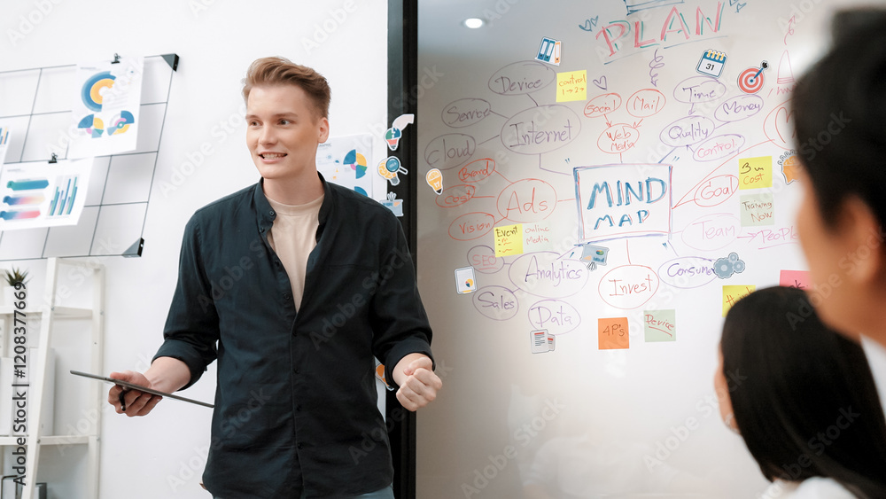 Professional male leader presents start up project by using mind map, colorful sticky notes and business statistic graph with confident while investor listening carefully. Immaculate. Professional male leader presents start up project by using mind map, colorful sticky notes and business statistic graph with confident while investor listening carefully. Immaculate.