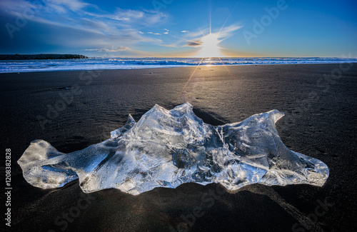 Loose segments of glacier washed out of Jokulsarlon glacial lake onto Diamond Beach on Iceland photo