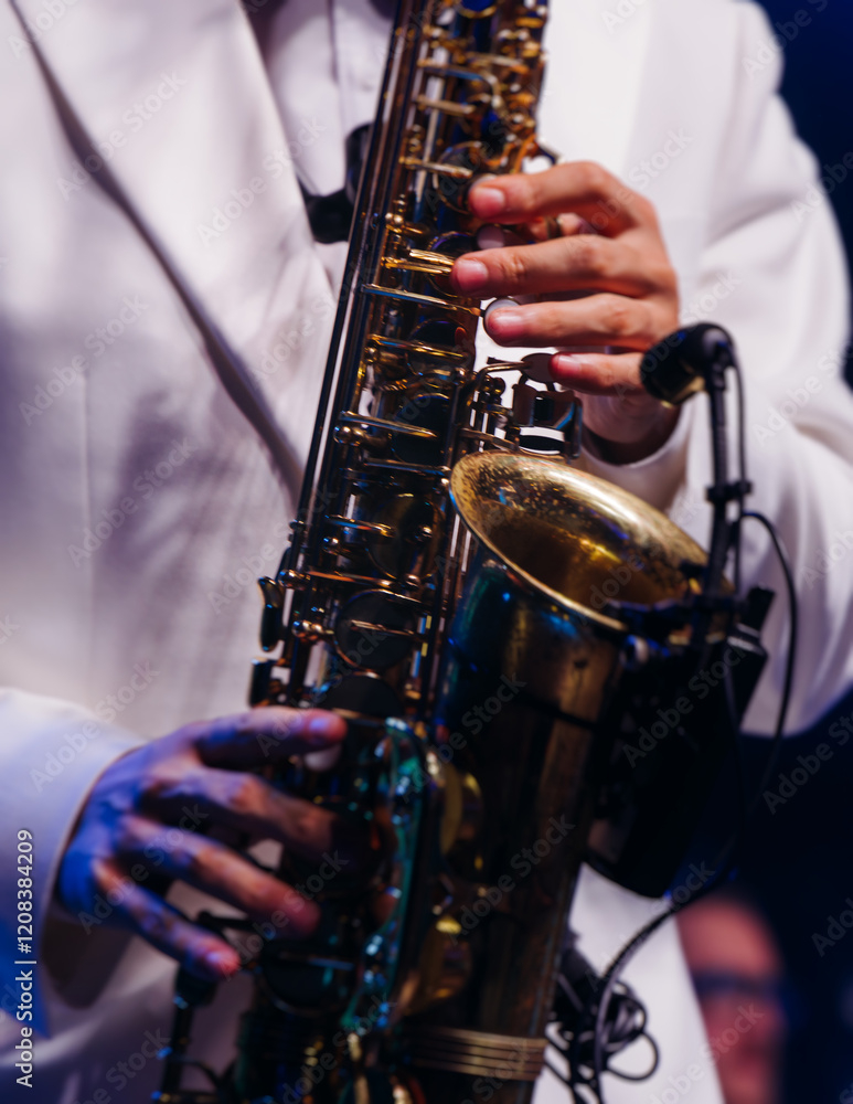 Fototapeta premium Concert view of saxophonist musician, saxophone sax player with vocalist and musical band during jazz orchestra show performing music on a stage in the scene lights, concert in a musical club hall