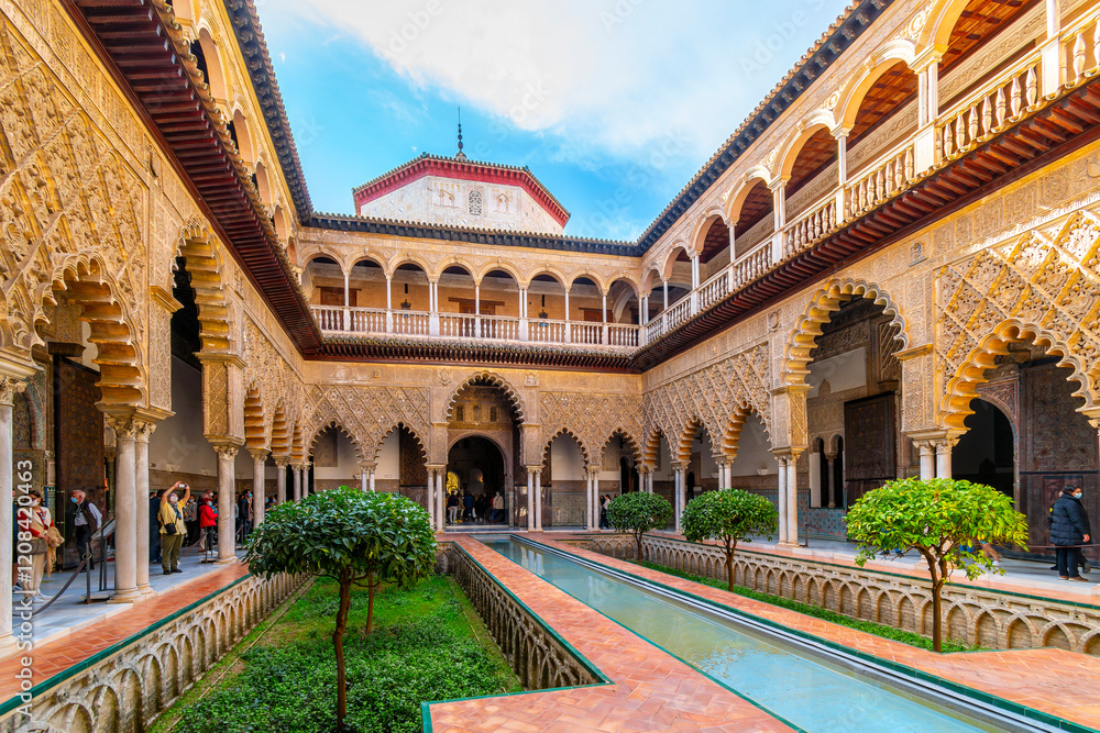 Fototapeta premium The inner courtyard with water feature at the Mudejar garden in the Royal Alcázar of Seville, also knows as al_Qasr al-Muriq.