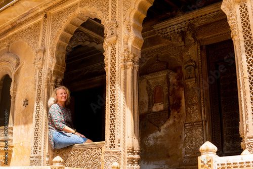 Young blonde European woman travelling in Rajasthan, exploring the old town of Jaisalmer, India