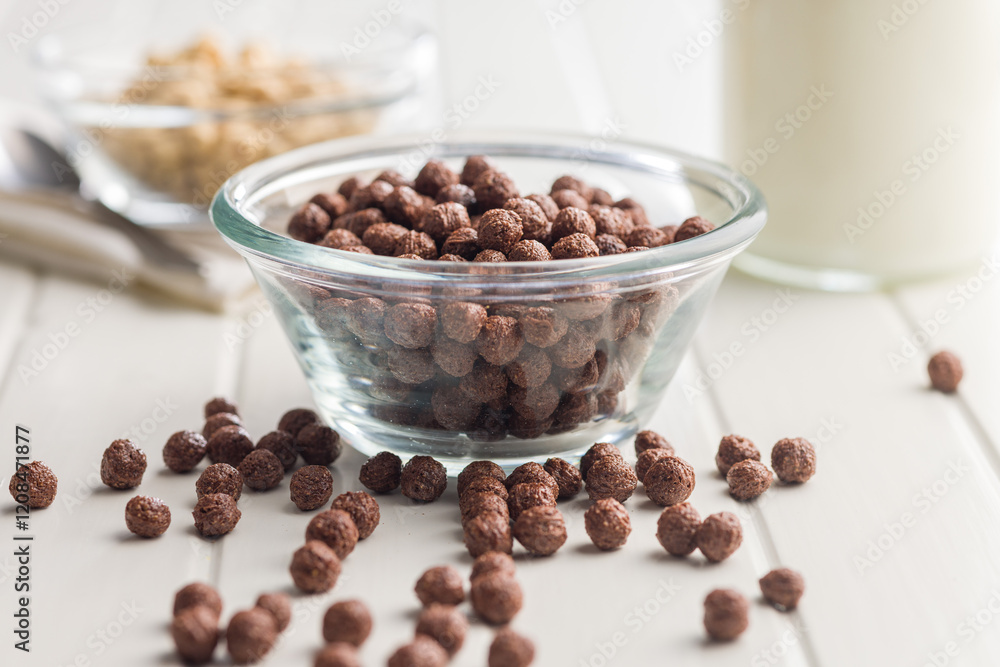 Breakfast cereal chocolate balls in bowl on white table. Breakfast cereal chocolate balls in bowl on white table.