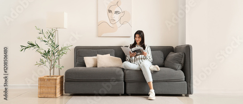 Young woman reading magazin...
