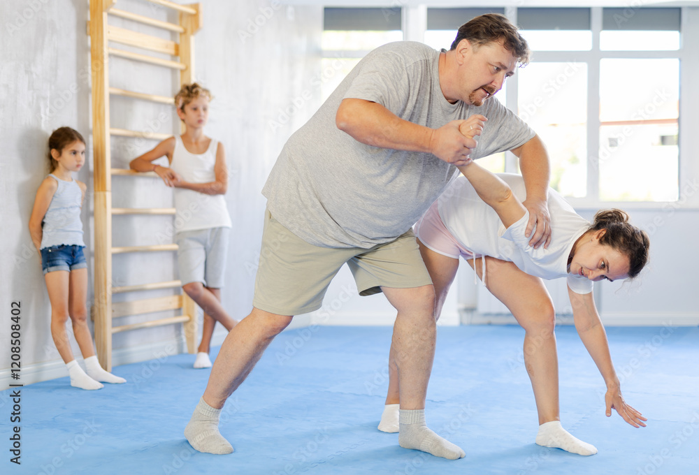 Man and woman training self-defense techniques in studio Man and woman training self-defense techniques in studio