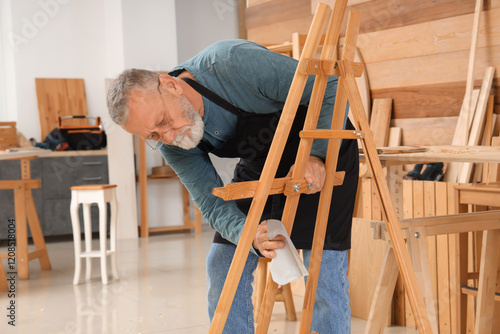 Mature carpenter working wi...
